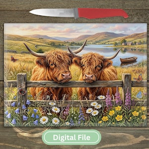 May include: A rectangular glass chopping board featuring a printed landscape of two brown Highland cattle standing behind a wooden fence in a field with wildflowers, a lake, and mountains, accompanied by a kitchen knife with a red handle.