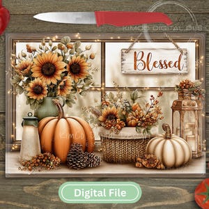 May include: A digital file featuring a fall-themed still life. The image includes sunflowers, pumpkins, a lantern, and a sign that reads "Blessed." A red knife and vegetables are also present, creating a rustic, autumnal aesthetic.