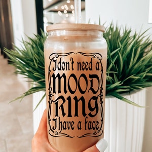 May include: A clear glass tumbler with a wooden lid and a black straw. The tumbler has a black graphic that reads "I don't need a mood ring I have a face".