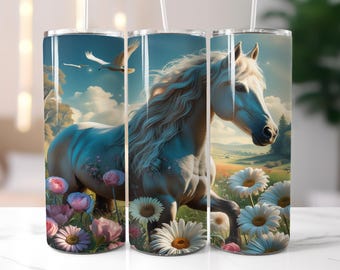 May include: A white horse tumbler with a serene landscape design. The tumbler features a majestic white horse in a field of flowers, with birds flying in the sky. The design includes pink and white flowers and daisies.