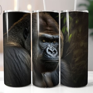 May include: Three stainless steel tumblers with a gorilla image. The gorilla is in a dark forest setting. The tumblers are black with a glossy finish.