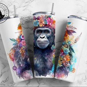 May include: A white stainless steel tumbler with a colorful floral design and a gorilla wearing a flower crown. The tumbler is 20 ounces and has a double-wall insulated design.