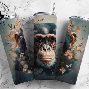 May include: A stainless steel tumbler with a colorful design featuring a chimpanzee face surrounded by flowers and butterflies. The tumbler is a popular choice for coffee, tea, or other beverages.