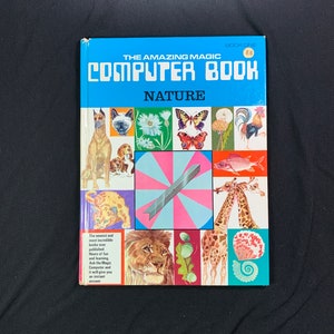 May include: A blue book with the title "The Amazing Magic Computer Book: Nature" on the cover. The cover features a variety of images, including a dog, a cat, a butterfly, a flower, a cockerel, a fish, a giraffe, a lion, and a seashell.