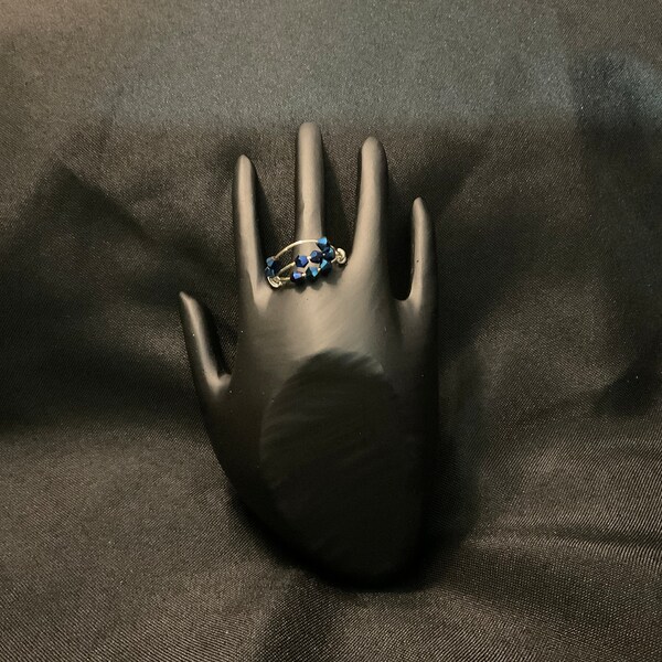 Anxiety ring w/moving beads. Silver wire w/blue bicone beads. Size 8.5. When feeling anxious, twist and move beads