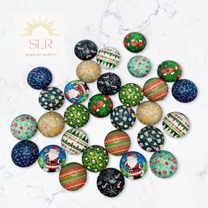 May include: Assortment of 20 round glass cabochons with various Christmas themed designs. The designs include Santa Claus, candy canes, baubles, and Christmas trees. The cabochons are approximately 2.5 cm in diameter.