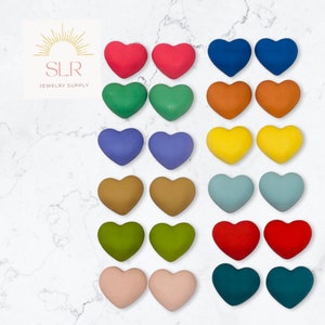May include: Assortment of 10 pairs of heart-shaped polymer clay earrings in various colours, including red, green, blue, yellow, brown, purple, pink, and teal.  SLR Jewelry Supply.