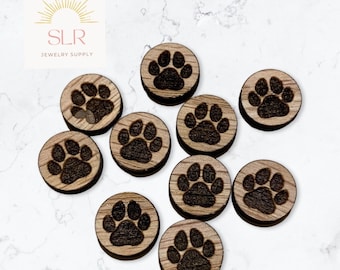 May include: Ten wooden round discs with a paw print design. The discs are a light brown colour with a dark brown paw print.