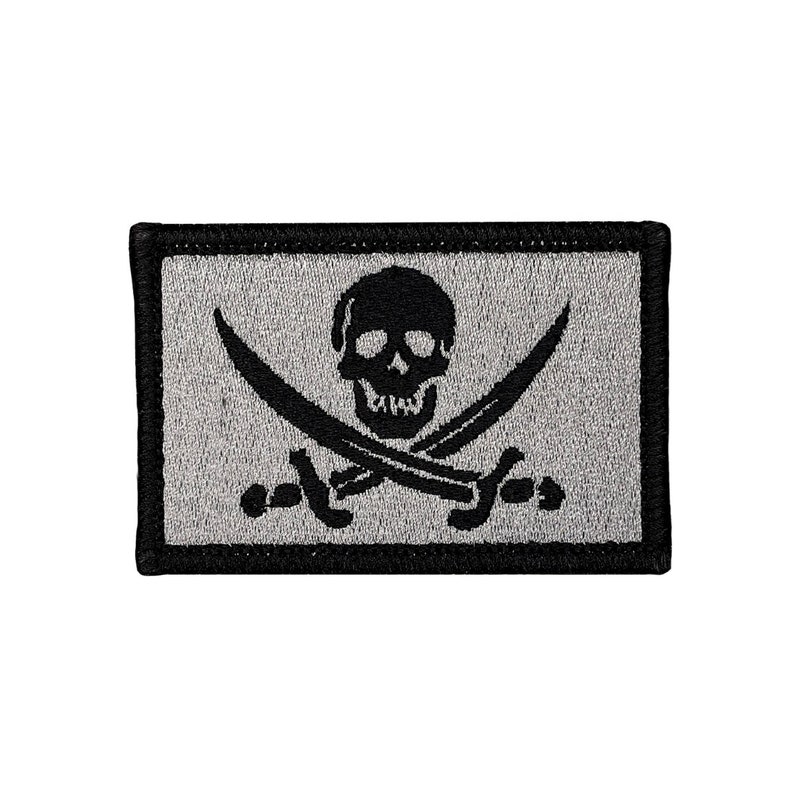 Calico Jack Rackham gray jolly roger pirate flag. 2x3 inch morale badge velcro tactical hook and loop. Made in USA