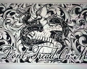 May include: Black and white illustration of a snake wrapped around a skull with a floral background. The text "Don't Tread On Me" is written below the skull.