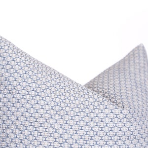 May include: A blue and white patterned throw pillow with a geometric design.