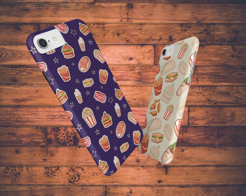 May include: Two phone cases with different food designs. The first case is purple with a pattern of burgers, fries, popcorn, ice cream cones, and stars. The second case is beige with a pattern of burgers, fries, chicken wings, and wraps.