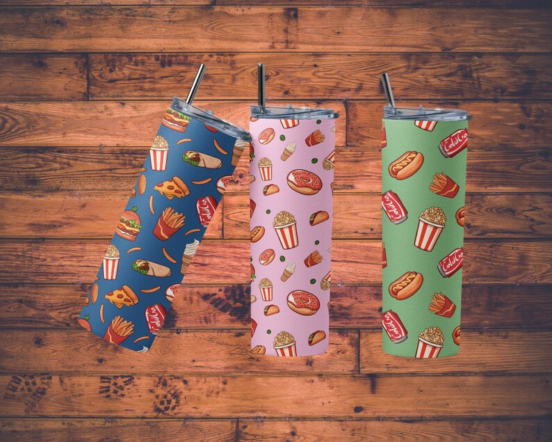 May include: Three stainless steel tumblers with different fast food designs. The first tumbler is blue with a pattern of pizza slices, french fries, burgers, and ice cream cones. The second tumbler is pink with a pattern of donuts, popcorn, tacos, and ice cream cones. The third tumbler is green with a pattern of hot dogs, french fries, popcorn, and soda cans.