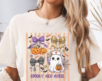 May include: An ivory t-shirt featuring a graphic print with orange vertical stripes, a purple bow, a gold bow, two jack-o'-lanterns, a ghost dressed as a nurse holding a syringe and a pumpkin, and the text SPOOKY NICU NURSE in purple letters.