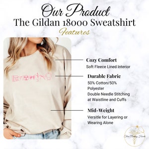 May include: A beige Gildan 18000 sweatshirt with a pink graphic print. The sweatshirt features a soft fleece lined interior, 50% cotton and 50% polyester fabric, double needle stitching at the waistline and cuffs, and is mid-weight for layering or wearing alone.