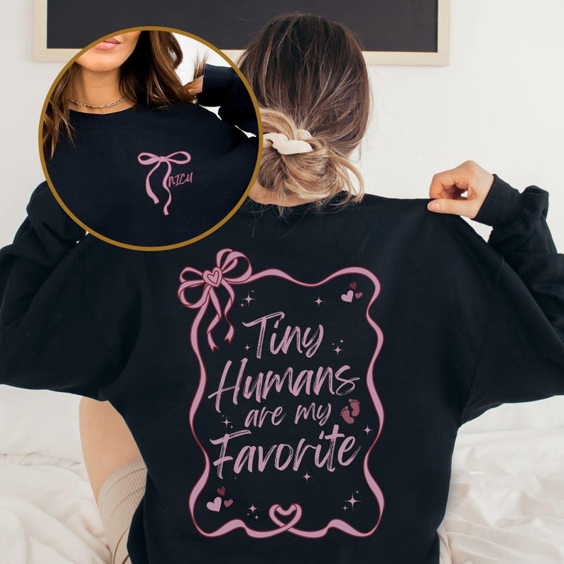 May include: Black sweatshirt with a pink ribbon and the text "Tiny Humans are my Favorite" in a pink frame with hearts and stars.