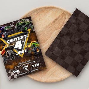 May include: A birthday party invitation featuring monster trucks in shades of green, orange, and purple. The invitation reads "Carter's 4th Jam" with event details. A brown checkered card sits on a wooden tray.
