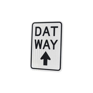 May include: A white sign with black text that reads "DAT WAY" with a black arrow pointing upwards.