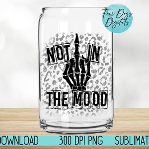 May include: A white can with a black and white leopard print design. The can has black text that reads "Not in the mood" with a black skeleton hand giving the middle finger.