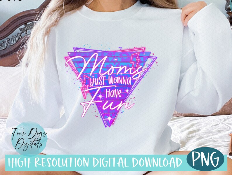 May include: White sweatshirt with a pink and blue graphic design that says "Mom's Just Wanna Have Fun" in a retro 80s style font.
