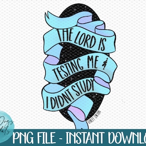 May include: A blue and purple ribbon with a black background and white text that reads "The Lord is testing me, I didn't study".