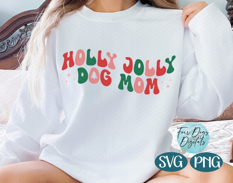 May include: White sweatshirt with the text "Holly Jolly Dog Mom" in red, green, and pink retro-style lettering. The text includes a small pink Christmas tree graphic.
