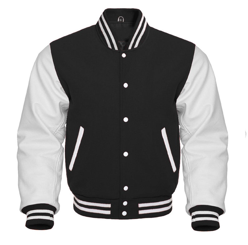 May include: A black and white varsity jacket with white leather sleeves and a black wool body. The jacket has a ribbed collar, cuffs, and waistband with white stripes. It features a button closure and two front pockets.