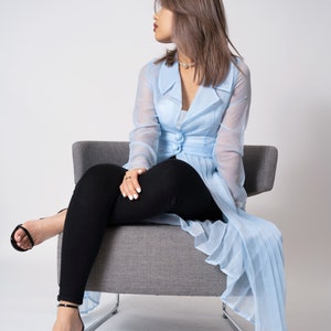 See-though pale blue pleated trench coat