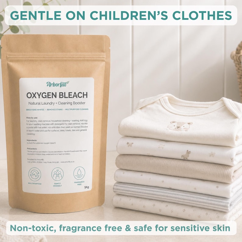 May include: A brown paper pouch of Arborfill Oxygen Bleach Natural Laundry and Cleaning Booster, 1kg, next to a stack of folded white and cream baby bodysuits. The label text includes instructions, ingredients, and icons for multipurpose, family friendly, and fragrance free use.
