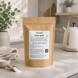 May include: A brown paper bag of Arborfill Citric Acid, a non-toxic cleaning compound. The label includes the text "EVERYDAY GENTLE EFFECTIVE" and directions for use. A small bowl of white powder and a wooden scoop are in the foreground.