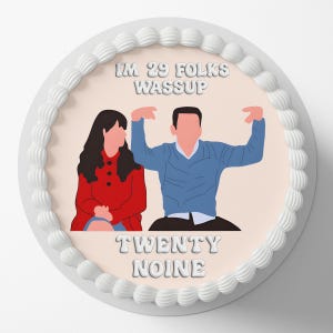 May include: A round cake with white frosting and a pink center. The cake features an illustration of two people and the text "I'M 29 FOLKS WASSUP" and "TWENTY NOINE". The cake is decorated with white frosting around the edges.