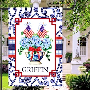 May include: A white ceramic mug with a black handle and the text "But First, Coffee" in a bold, black font. The mug is set against a blurred background, suggesting a cozy setting.