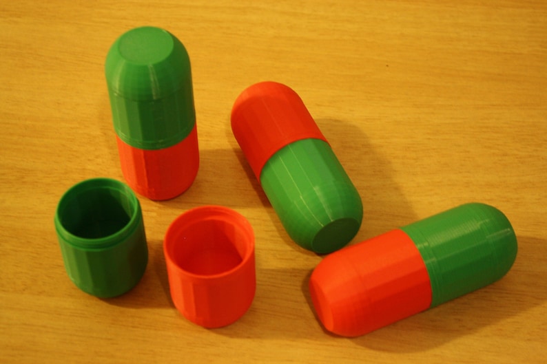 Opened Christmas-Themed Small Storage Capsules - Red and Green Organization and Cosplay Accessories A lifestyle shot showing one of the small storage capsules with its lid screwed open, revealing its interior.
