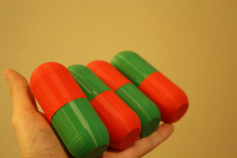 Christmas-Themed Small Storage Capsules - Red and Green Organization and Cosplay Accessories A top-down view of the four small storage capsules in red and green, arranged on a neutral background with a Christmas theme held in one hand.