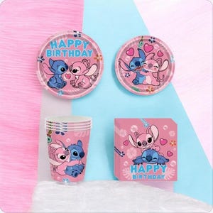 May include: A set of party supplies featuring Stitch and Angel characters, including two round paper plates with the text HAPPY BIRTHDAY, a stack of paper cups, and a square pack of napkins, all decorated with pink and blue floral patterns.