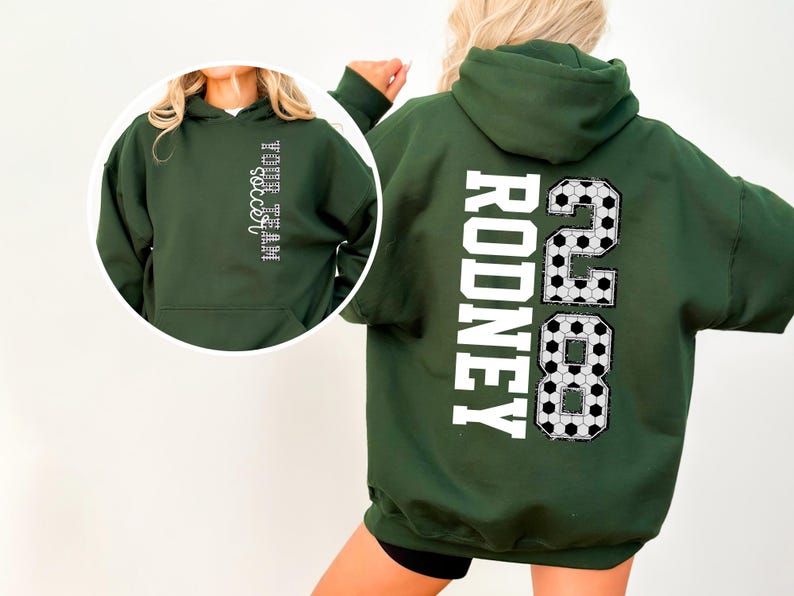May include: Dark green hooded sweatshirt with white text on the back that reads "RODNEY 2888". The front of the sweatshirt has the text "YOUR TEAM soccer" in white. The design incorporates soccer ball patterns.