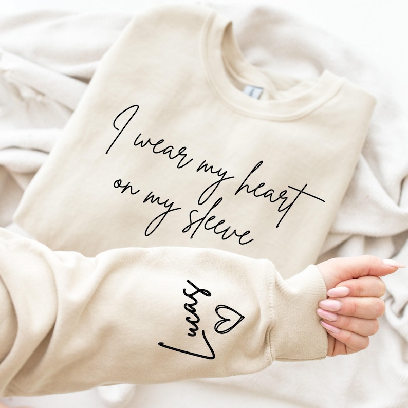 I Wear My Heart On My Sleeve Sweatshirt for Mothers Day, Custom Mama Sweatshirt with Kids Name on Sleeve, Mother Day Gift for Mom, Mom Gift image 1