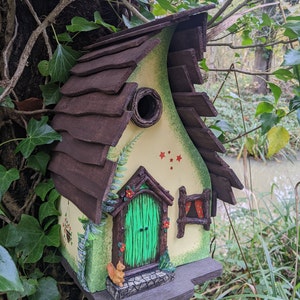 Whimsical wooden yellow birdhouse with window, door in a fairy theme. A great gift for gardeners. Handcrafted bird shelter, bird box.