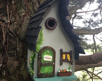 Beautiful hand painted bird box with a fairy house theme. Wooden bird box with a fairy door, enchanting gift for all garden lovers,