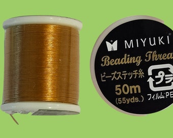 One spool of Miyuki beading thread - 50 meters gold colored