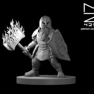 May include: A miniature figurine of a dwarf warrior wearing armor and holding a flaming hammer and a shield. The dwarf has a beard and is wearing a helmet.