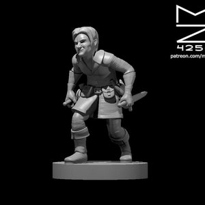 May include: A gray miniature figurine of a person wearing a tunic and holding a dagger. The figurine is standing on a round base.