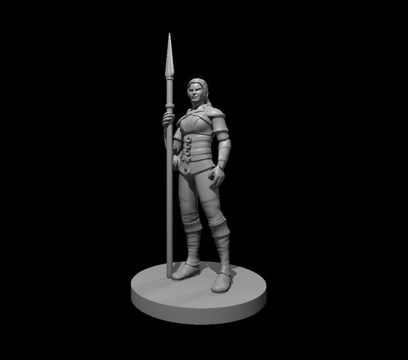 May include: A gray 3D printed miniature of a female figure holding a spear. The figure is wearing armor and is standing on a round base.