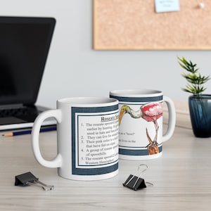 May include: White ceramic coffee mug with a blue and white illustration of a roseate spoonbill. The mug has a handle and text that reads: "Roseate Spoonbill". 1. The roseate spoonbill was a popular food source for Native Americans earlier by hunting, for its feathers. 2. They can live for as long as 30 years. 3. Their pink color is a result of a pigment that have fed on algae. 4. A group of roseate spoonbills is called a "bowl". 5. The roseate spoonbill lives in the Western Hemisphere."