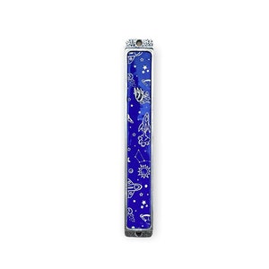 May include: A silver-toned mezuzah case with a vibrant blue background. The case features a design of white space-themed illustrations, including rockets, stars, and planets. The rectangular case is approximately 5 inches long.