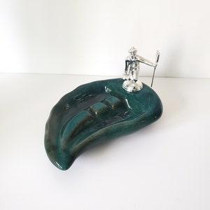 Vintage Ashtray Blue Mountain Style with Silver Statue of Man Curling & Holding a Corn Broom - no duty for shipments to the USA