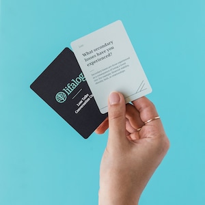 May include: A set of conversation cards with a teal leaf logo and the text "lifalog Loss Talks Conversation Cards". The card in the foreground is light gray with the text "Loss What secondary losses have you experienced? Secondary losses are those experienced as a consequence of losing a loved one. For example, financial stability, identity, faith, or relationships."