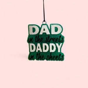 May include: Green and white ornament with the text "DAD in the streets DADDY in the sheets".