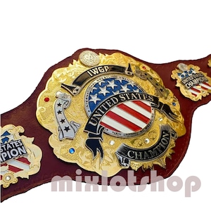 May include: A gold and red wrestling championship belt with the words "IWGP International Wrestling Grand Prix United States Champion" and "New Japan Pro Wrestling" on it. The belt has a red, white, and blue American flag design.