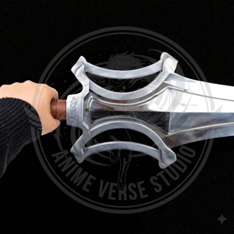 May include: A silver sword with a brown handle. The sword has a unique design with curved, decorative elements. The blade is shiny and reflects light. The handle is held by a person. The image has a dark background with the text "ANIME VERSE STUDIO".
